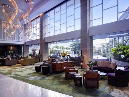 a lobby of a hotel with couches and chairs at Grand Mercure Bandung Setiabudi in Bandung