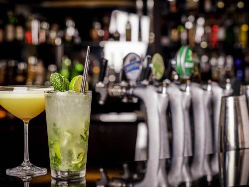a drink sitting on top of a bar at Mercure Melbourne Albert Park in Melbourne