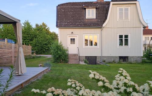 a small house with a yard with a house at Gorgeous Home In Tingsryd With Kitchen in Tingsryd
