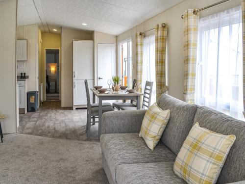 a living room with a couch and a table at Lodge 43 Bridlington Holiday Park - Uk47517 in Carnaby