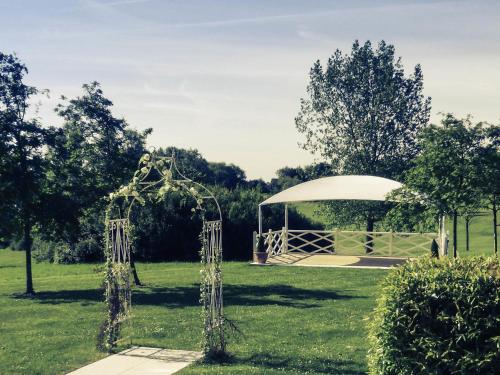 a gazebo in the middle of a park at Mercure Milton Keynes Hotel in Milton Keynes