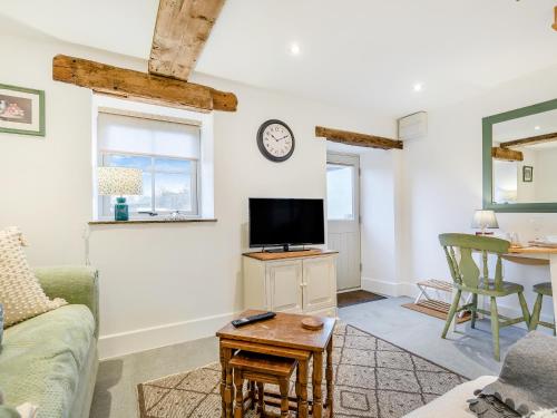 a living room with a couch and a tv at Clarence Cottage - Uk47494 in Waterfall