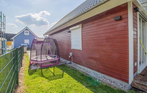 a red house with a bench on the side of it at Amazing Home In Wandlitz With Sauna in Wandlitz