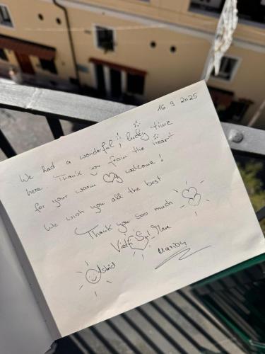 a piece of paper with writing on it on a bench at Isabel’s house in Vietri sul Mare