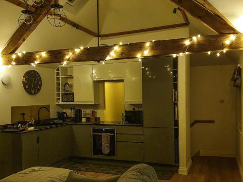 a kitchen with lights on the ceiling in a room at The Coach House in Fordingbridge