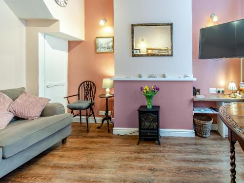 a living room with a couch and a table at Sea Dog Cottage in Scarborough