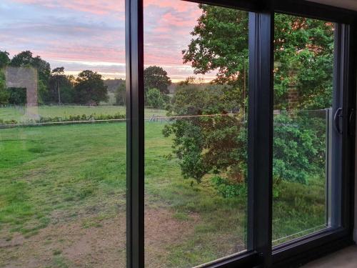 a window with a view of a field of grass at The Coach House in Fordingbridge