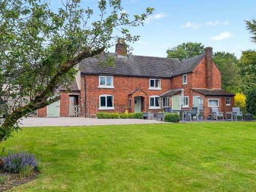 a brick house with a lawn in front of it at Brynfields in Shirley