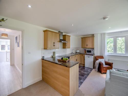 a kitchen with wooden cabinets and a counter top at The Nest in Surfleet