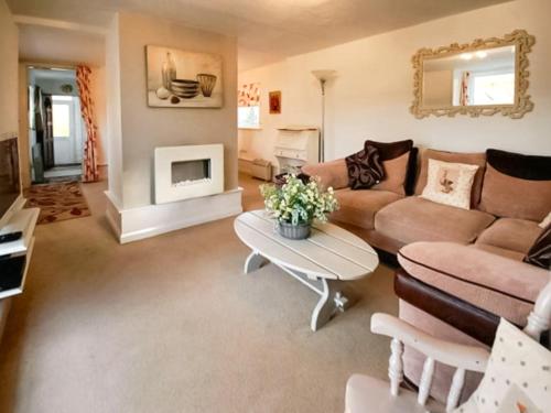 a living room with a couch and a table at Chainbridge Cottage in Whitby