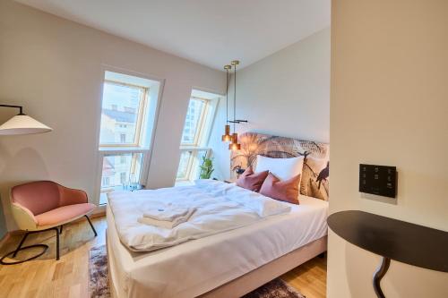 a bedroom with a bed and a chair at Hotel Karol in Vienna