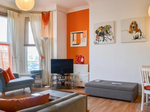 a living room with a couch and a tv at Seagulls Studio in Bridlington