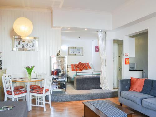 a living room with a couch and a table at Seagulls Studio in Bridlington