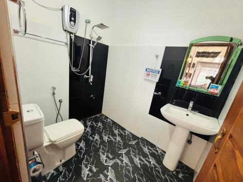 a bathroom with a toilet and a sink at Belmount Ella in Ella