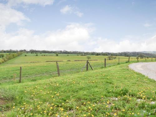 a fence in a field next to a road at White Heather Barn in Swanwick