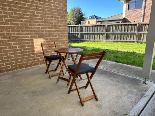 two chairs and a table on a patio at Stylish four bedroom family retreat in Saltwater Coast in Point Cook
