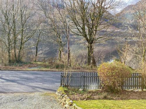 a road with a fence on the side of the road at Alt Na Blathaich in Coirantee