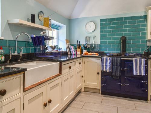 a kitchen with a sink and a dishwasher at No Place in Sennen