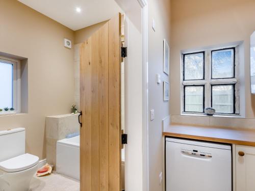 a bathroom with a toilet and a sink at South Lodge in Great Driffield