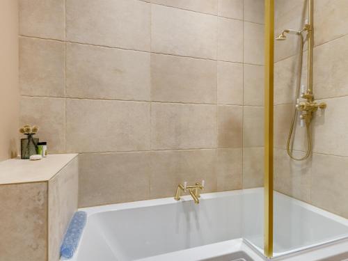 a bathroom with a shower and a bath tub at South Lodge in Great Driffield