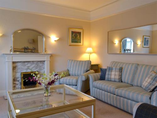 a living room with two couches and a fireplace at Linton in Keswick
