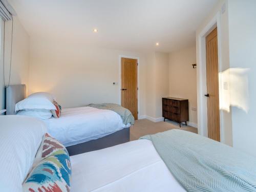 a bedroom with two beds and a dresser at Moorgate Lodge - Uk47742 in Kelbrook