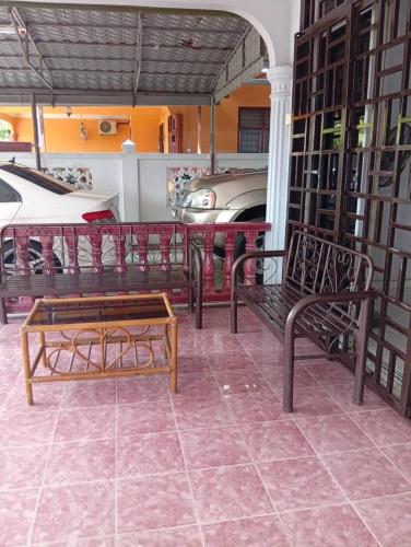 a group of benches in a room with cars at Rumah Inap ABC in Pasir Mas