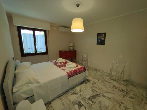 a bedroom with a bed with a marble floor at Iride in Portovenere
