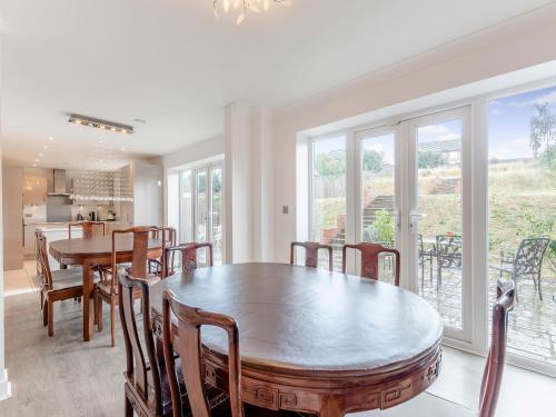 a kitchen and dining room with a table and chairs at Carey in Eastchurch