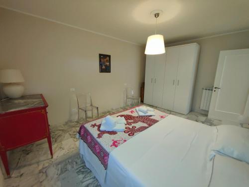 a bedroom with a bed and a table and a lamp at Iride in Portovenere