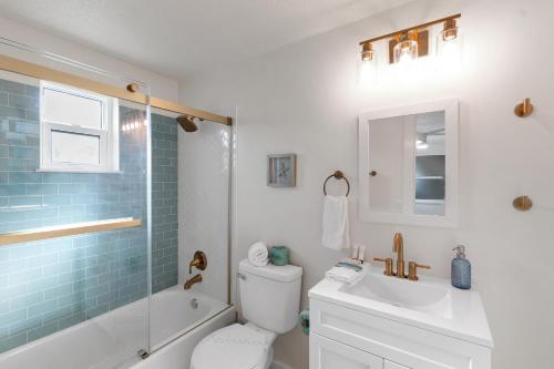 a bathroom with a toilet and a sink and a shower at Beach Getaway on Anna Maria Island in Holmes Beach