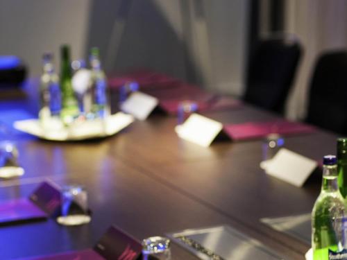 a wooden table with bottles on top of it at Mercure Darlington King's Hotel in Darlington