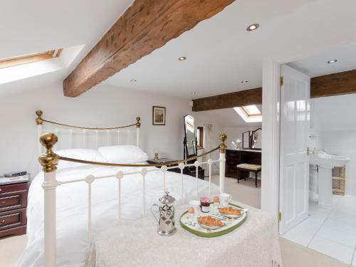a bedroom with a bed with a plate of food at Lillegarth in Bradwell