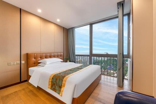 Postel nebo postele na pokoji v ubytování JunHome International Apartment-Beijing Rd A-mall