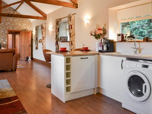 a laundry room with a washer and dryer at The Stables At Grange Barn in Rise