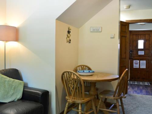 a room with a table and chairs and a couch at Ardennes Cottage in Sewerby