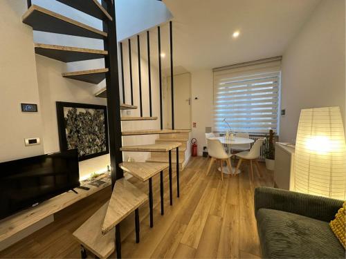 a living room with a fireplace and a dining room at Il nido della rondine in Ostra