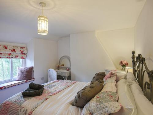 a bedroom with a large bed with pillows on it at Bodeinion in Llanfair Caereinion