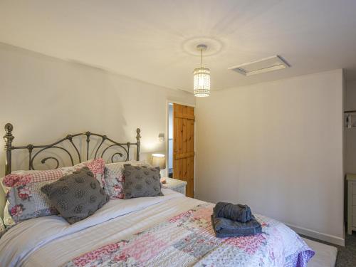 a bedroom with a large bed with pillows at Bodeinion in Llanfair Caereinion