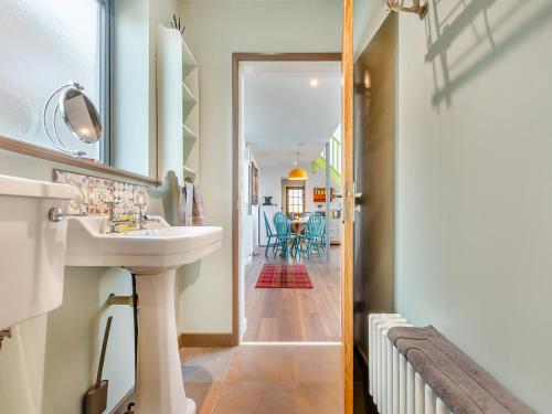 a bathroom with a sink and a mirror and a hallway at The Sanctuary in Sleaford