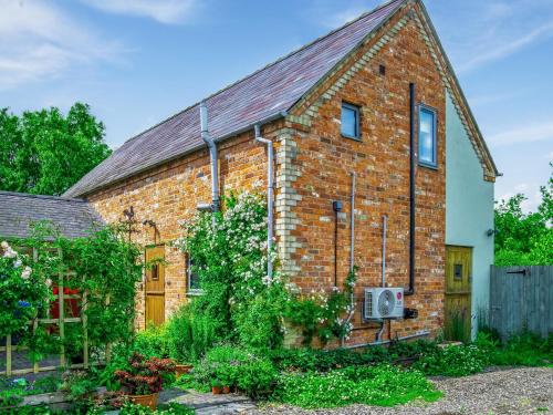 a brick house with a garden in front of it at The Sanctuary in Sleaford