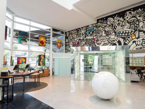 a room with a large white ball in front of a wall with graffiti at Pullman Sao Paulo Vila Olimpia in Sao Paulo