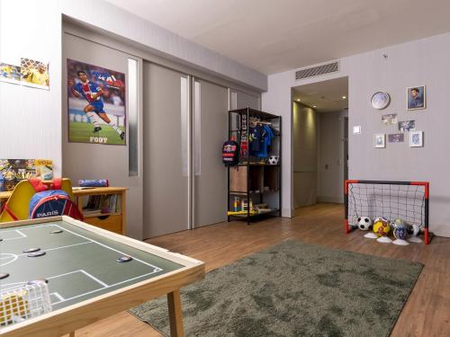 a living room with a ping pong table at Pullman Sao Paulo Vila Olimpia in Sao Paulo