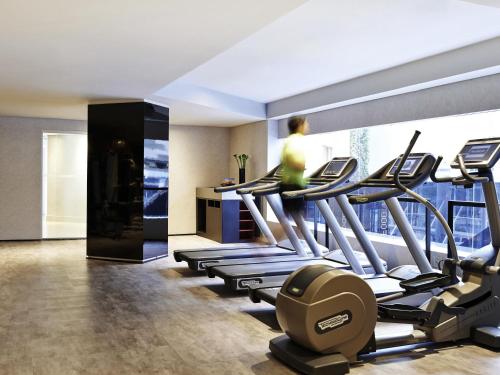 a room with a row of treadmills in a gym at Pullman Sao Paulo Vila Olimpia in Sao Paulo