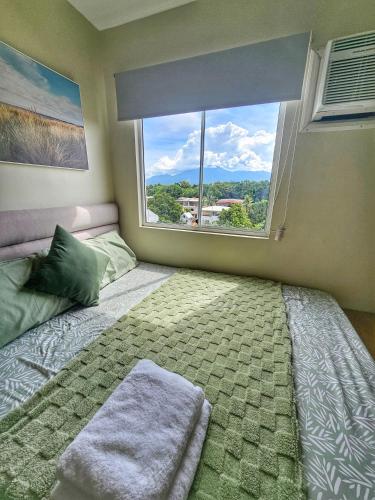 a bedroom with a bed with a large window at Vito Condotel in Piapi