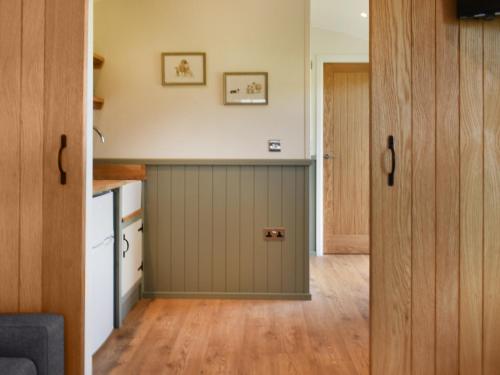 a kitchen with a green door in a room at Meadows View Shepherd's Hut in Cockermouth