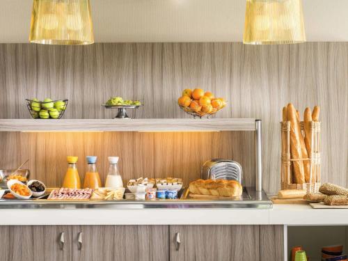 a shelf with bread and other food items on it at ibis Styles St Gilles Croix de Vie centre-ville in Saint-Gilles-Croix-de-Vie