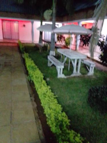 a picnic table in the grass in a yard at Royal olimpia in Livingstone