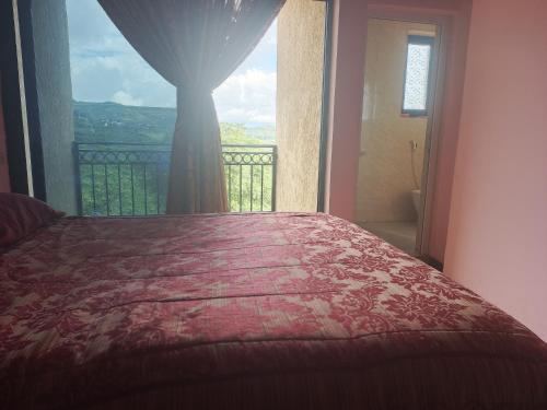 a bedroom with a bed and a window with a view at Honey Land Hotel Lalibela in Lalībela