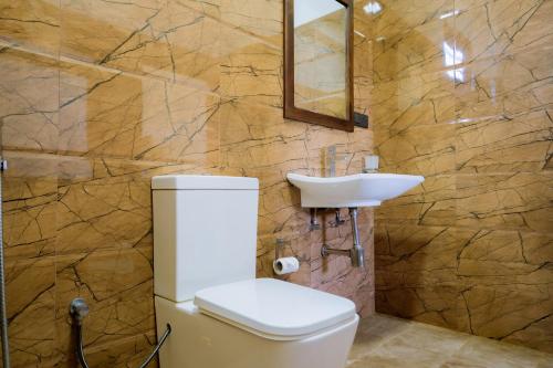 a bathroom with a toilet and a sink at Blue Sky Hotel Yala in Yala